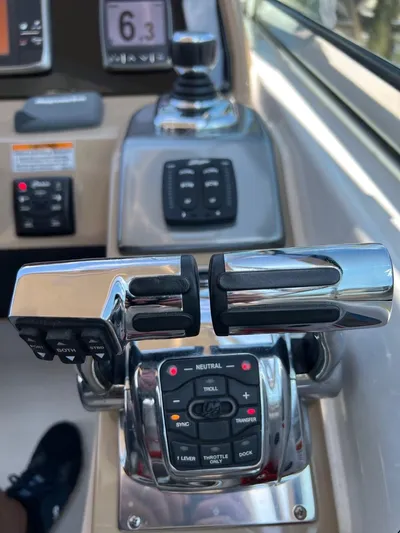 Last One III Yacht Photos Pics Close-up of the throttle controls on a 2013 Formula 370 Super Sport boat.