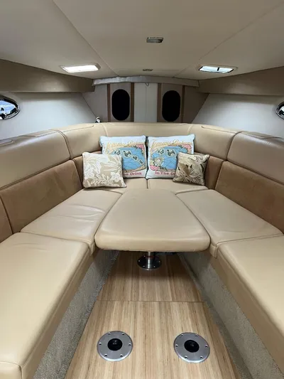 Last One III Yacht Photos Pics 2013 Formula 370 Super Sport cabin with beige leather seating and decorative pillows.