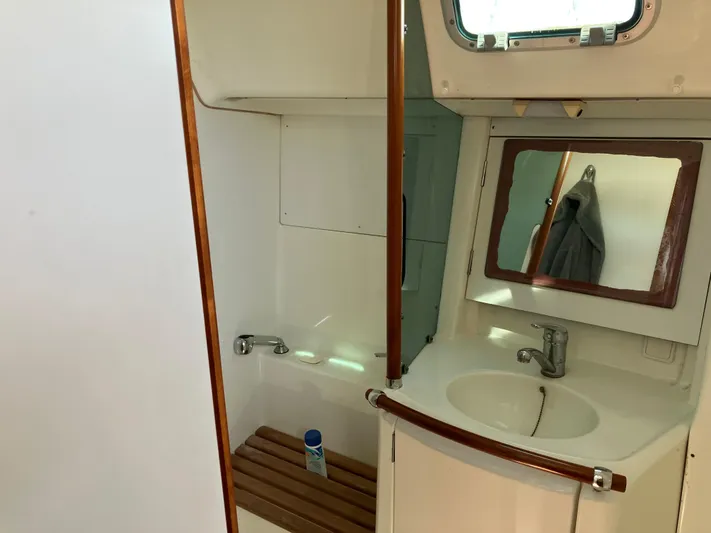 Egret Yacht Photos Pics Interior of 2001 Beneteau Oceanis Clipper 361 yacht bathroom with sink and mirror.