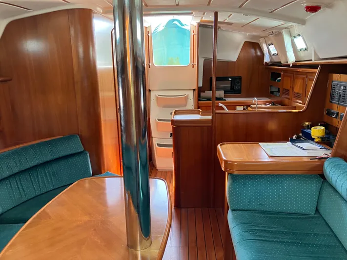 Egret Yacht Photos Pics Interior of 2001 Beneteau Oceanis Clipper 361 yacht, featuring wood finishes and seating area.