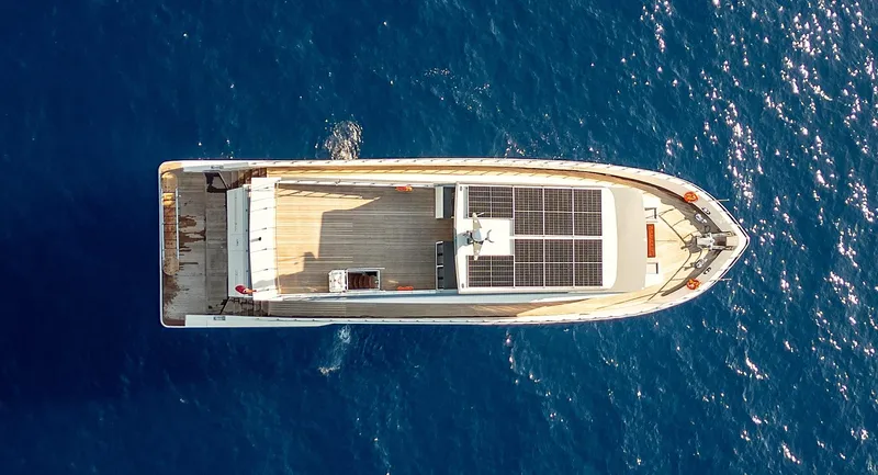  Yacht Photos Pics Aerial view of 2024 Custom Modern Trawler RPH on blue ocean water.