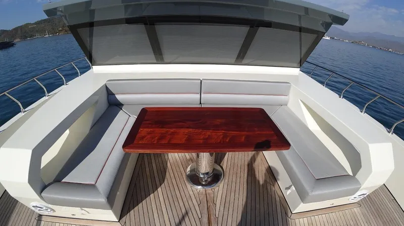  Yacht Photos Pics Modern Trawler RPH 2024 with sleek deck seating and polished wooden table.