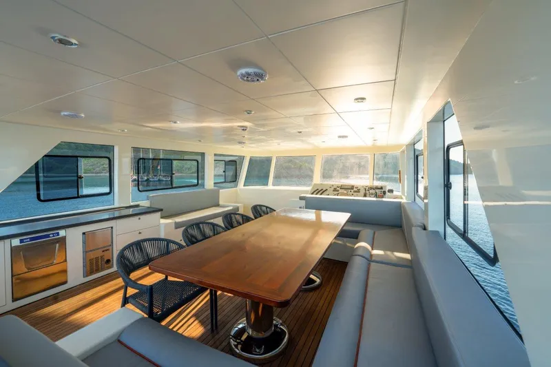  Yacht Photos Pics Luxurious interior of 2024 Custom Modern Trawler RPH with dining area and panoramic windows.