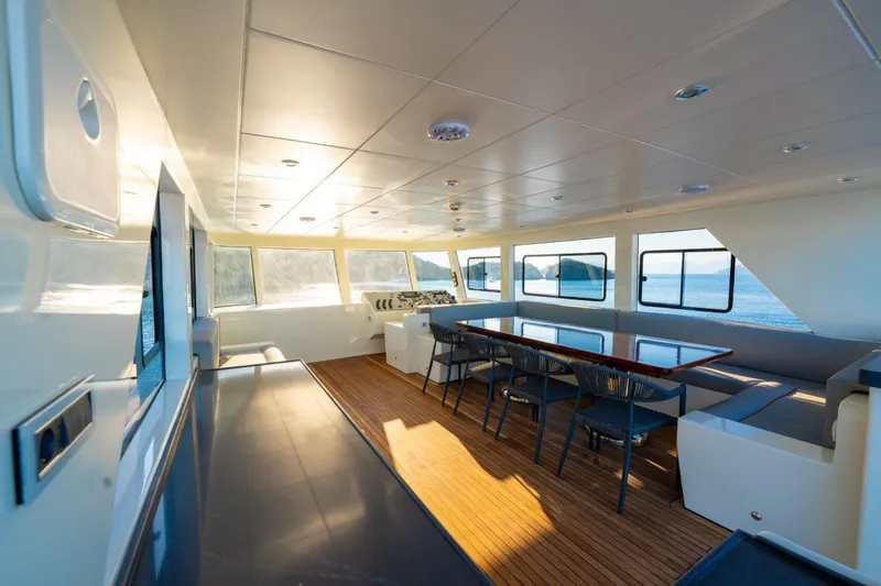  Yacht Photos Pics Luxurious interior of 2024 Custom Modern Trawler RPH with panoramic windows and elegant dining area.