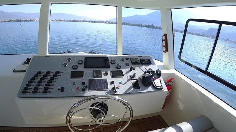  Yacht Photos Pics Modern Trawler RPH 2024 helm with panoramic sea view and advanced navigation controls.