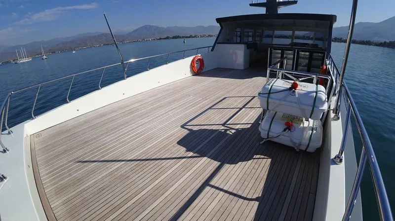  Yacht Photos Pics Modern Trawler RPH 2024 with spacious deck, docked in scenic harbor.