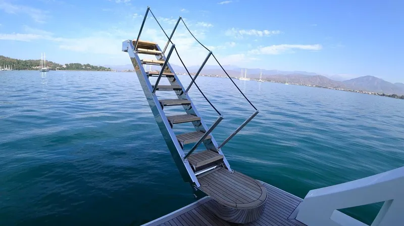  Yacht Photos Pics Staircase on a 2024 Custom Modern Trawler RPH, leading to serene ocean view.