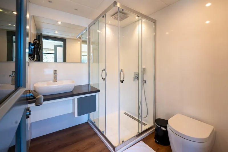  Yacht Photos Pics Modern bathroom on 2024 Custom Modern Trawler RPH with glass shower and sleek fixtures.