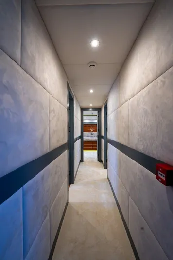  Yacht Photos Pics Narrow hallway inside 2024 Custom Modern Trawler RPH, featuring sleek design and ambient lighting.