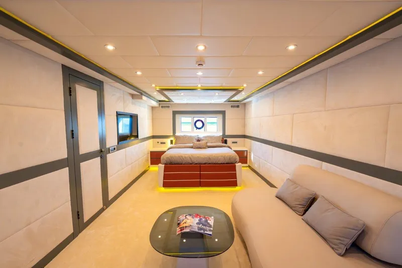  Yacht Photos Pics Luxurious 2024 Custom Modern Trawler RPH bedroom with elegant decor and cozy seating area.