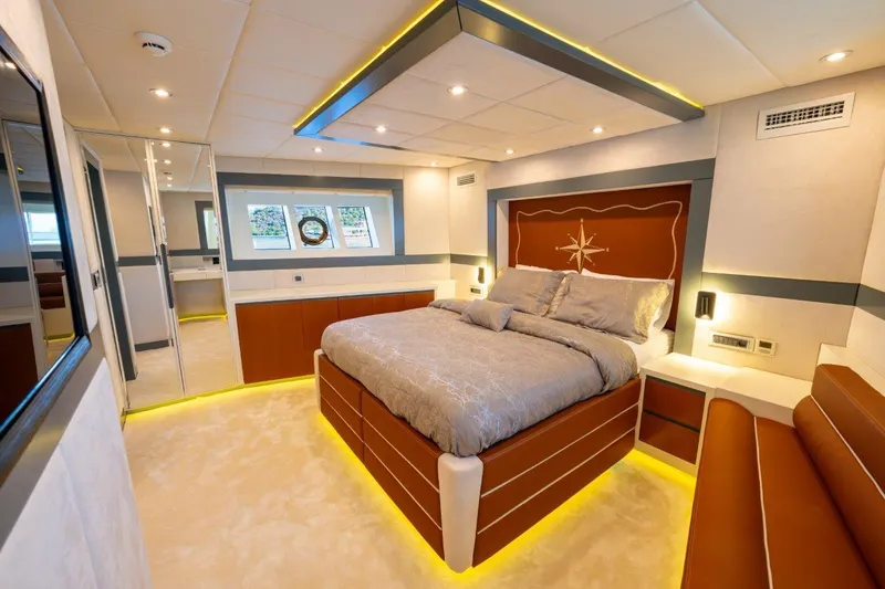 Yacht Photos Pics Luxurious bedroom in 2024 Custom Modern Trawler RPH with elegant lighting and nautical decor.