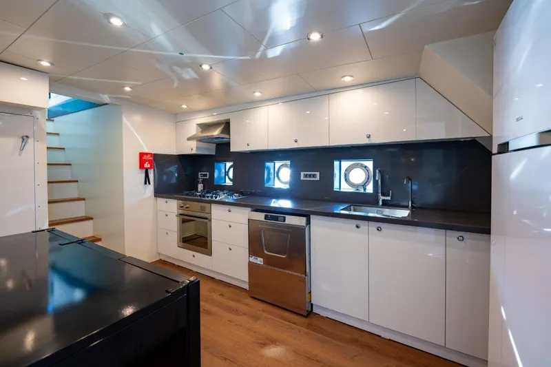  Yacht Photos Pics Modern kitchen in 2024 Custom Modern Trawler RPH, featuring sleek cabinetry and stainless steel appliances.