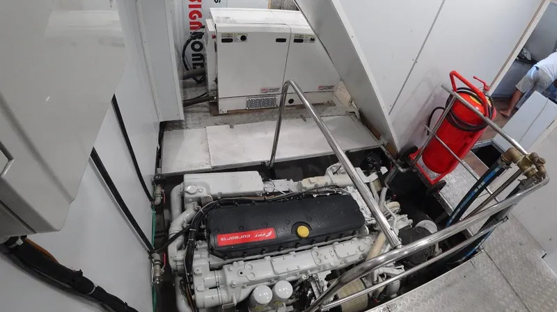  Yacht Photos Pics Engine room of 2024 Custom Modern Trawler RPH with visible machinery and fire extinguisher.