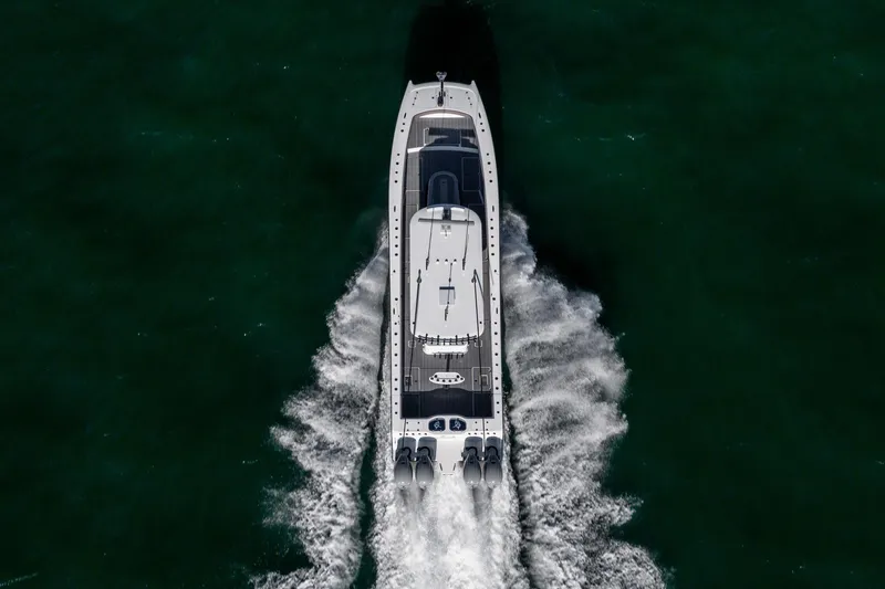 Jackie B Yacht Photos Pics Aerial view of 2024 Freeman 47 boat cruising through dark green waters.