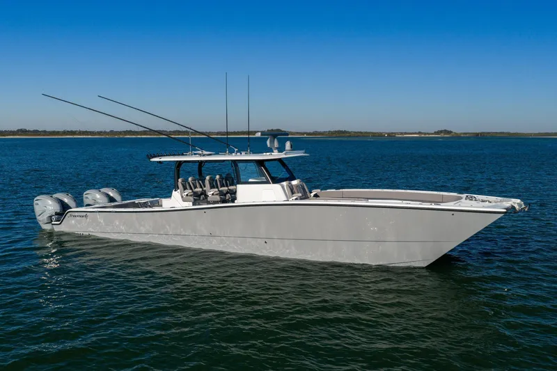Jackie B Yacht Photos Pics 2024 Freeman 47 boat on calm blue water under clear sky.