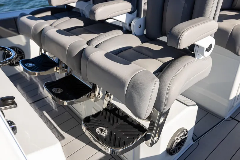 Jackie B Yacht Photos Pics Luxury seating on 2024 Freeman 47 boat with gray upholstery and footrests.