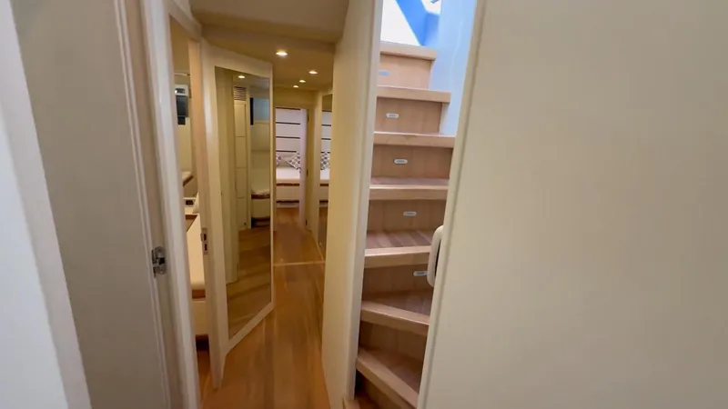 Yacht Photos Pics Interior of 2005 Astondoa 72 yacht with wooden stairs and hallway.