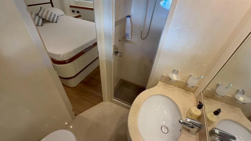  Yacht Photos Pics Luxurious bathroom and bedroom in a 2005 Astondoa 72 yacht.