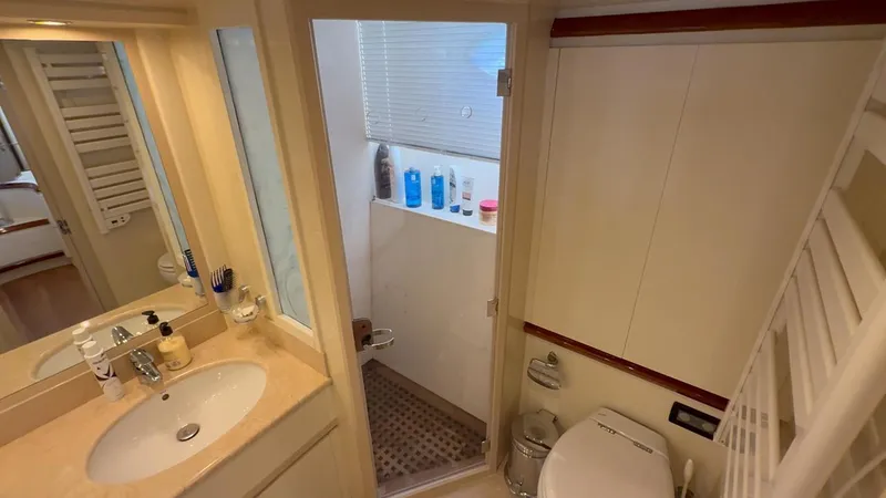  Yacht Photos Pics Bathroom interior of 2005 Astondoa 72 yacht, featuring sink, shower, and toilet.