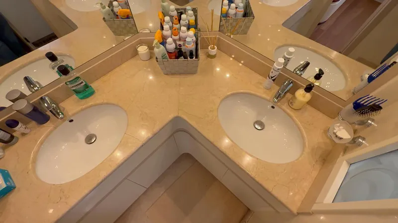  Yacht Photos Pics Luxurious bathroom with dual sinks and marble countertop on a 2005 Astondoa 72 yacht.