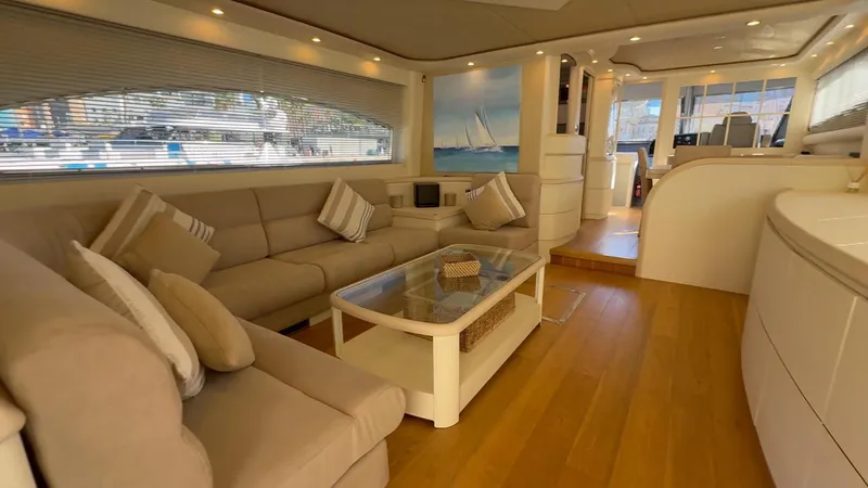  Yacht Photos Pics Luxurious interior of 2005 Astondoa 72 yacht with beige seating and wooden flooring.