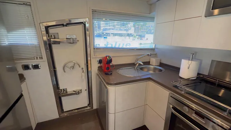  Yacht Photos Pics Modern kitchen interior of 2005 Astondoa 72 yacht with sleek appliances and compact design.