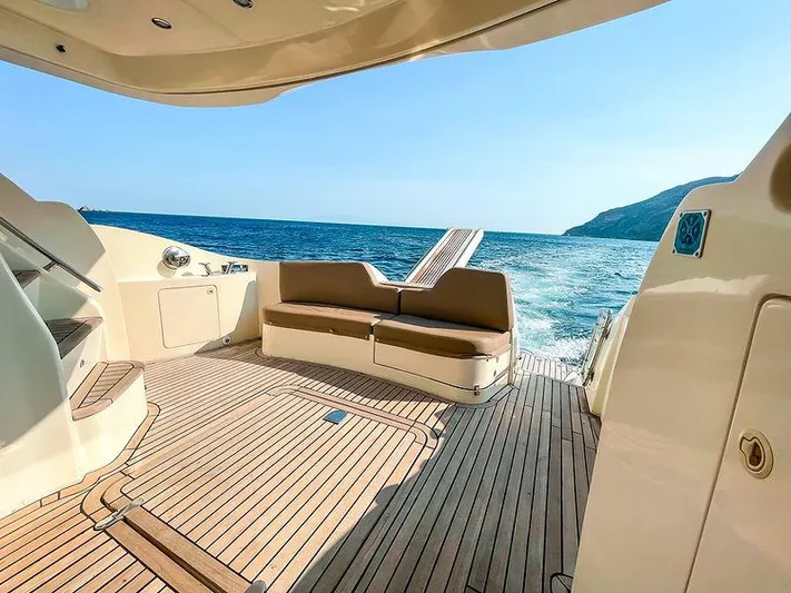  Yacht Photos Pics Luxurious 2007 Aicon 52 yacht deck with seating, cruising on open sea.