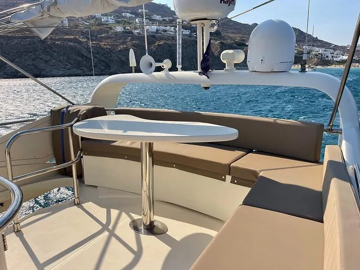  Yacht Photos Pics Luxurious 2007 Aicon 52 yacht deck with seating and table, overlooking scenic coastal waters.