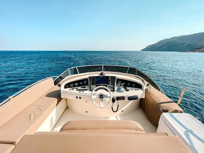  Yacht Photos Pics Aicon 52 yacht helm, 2007 model, cruising on serene blue waters.