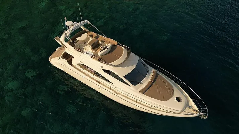  Yacht Photos Pics Luxury Aicon 52 yacht from 2007 on clear blue water, aerial view.