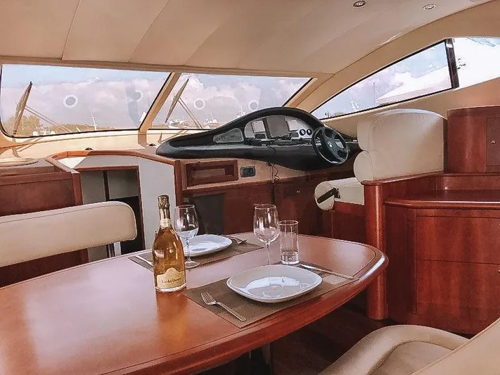  Yacht Photos Pics Luxurious interior of 2007 Aicon 52 yacht with dining table and helm.