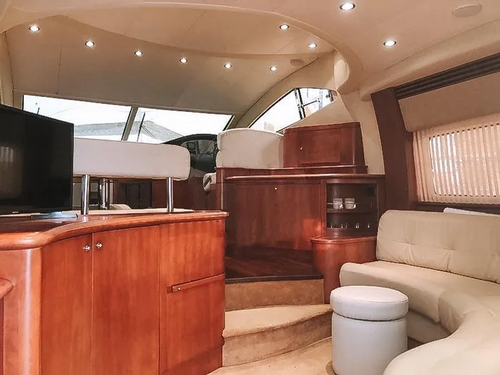  Yacht Photos Pics Luxurious interior of a 2007 Aicon 52 yacht with elegant wood finishes and plush seating.