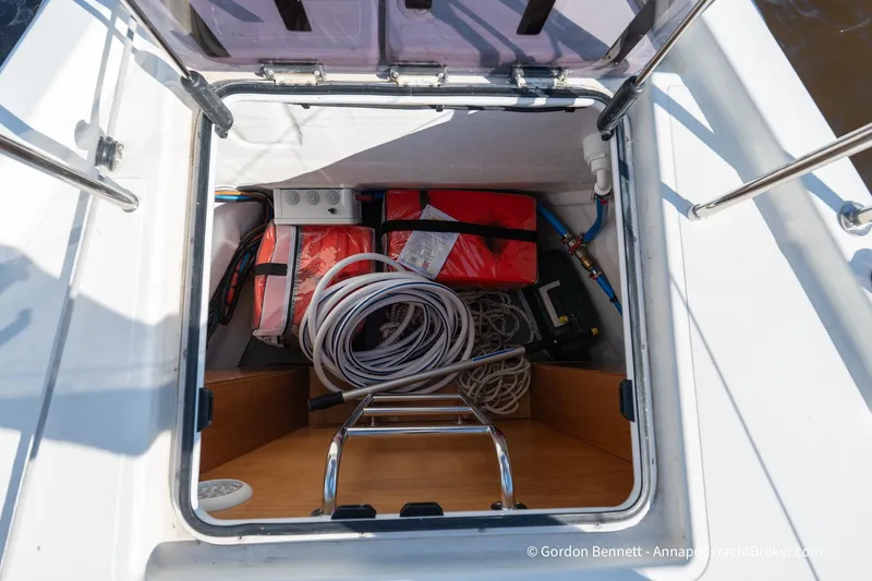Boat Tox Yacht Photos Pics Storage compartment of 2022 Jeanneau Sun Odyssey 440 yacht with ropes and equipment.