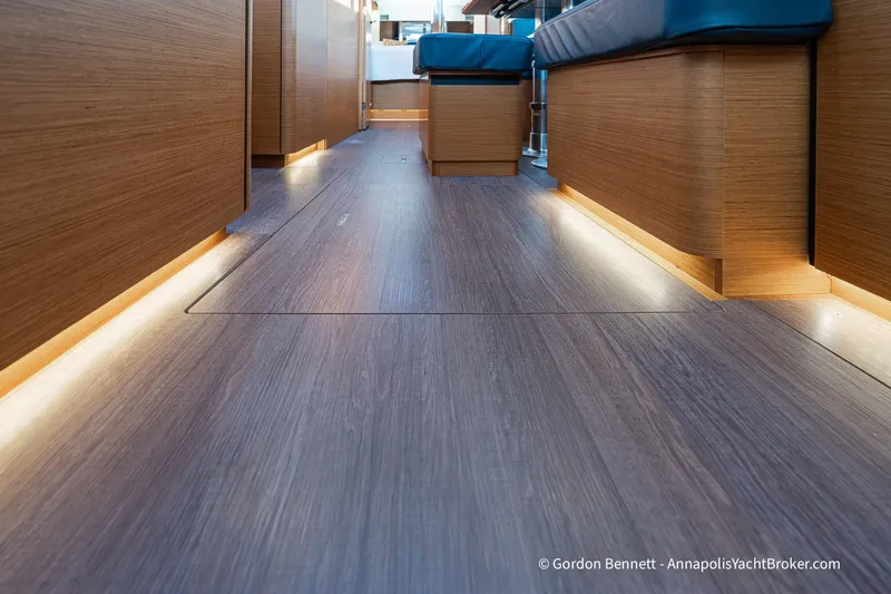 Boat Tox Yacht Photos Pics Interior of 2022 Jeanneau Sun Odyssey 440 yacht with sleek wooden flooring and ambient lighting.