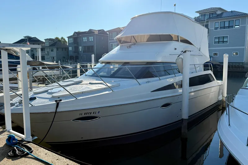  Yacht Photos Pics 2009 Carver 43 Super Sport yacht docked at a marina, surrounded by waterfront buildings.