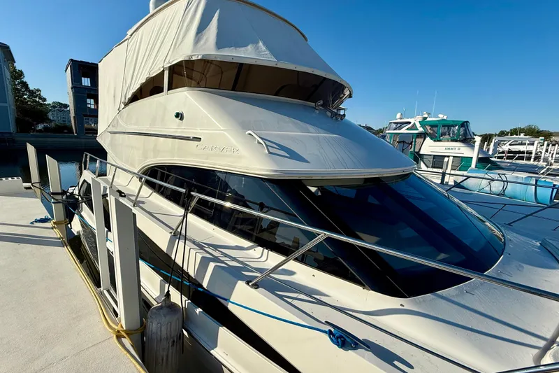  Yacht Photos Pics 2009 Carver 43 Super Sport yacht docked at marina under clear blue sky.