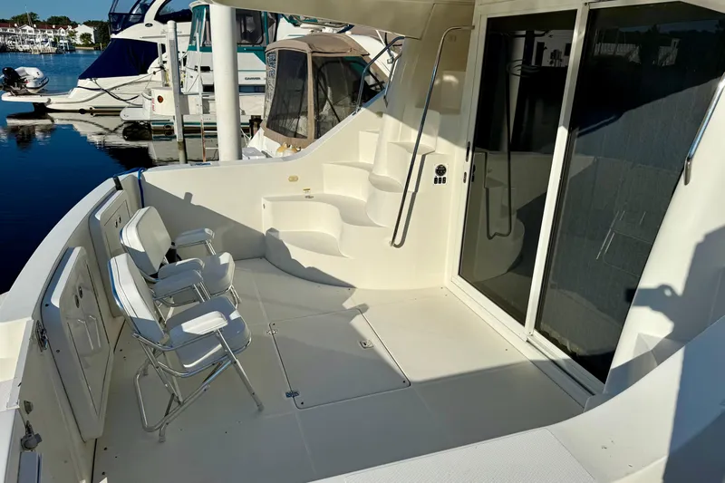  Yacht Photos Pics 2009 Carver 43 Super Sport yacht deck with seating and sliding glass door.