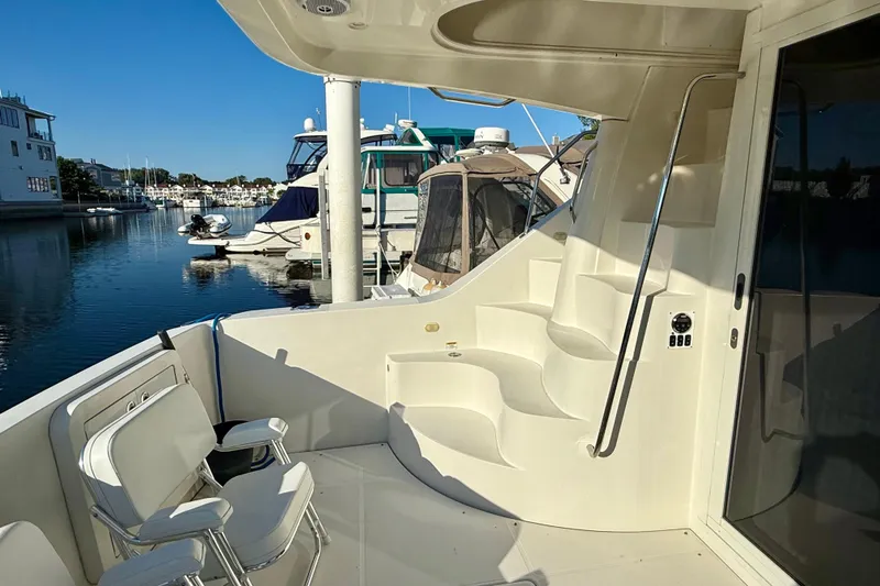  Yacht Photos Pics 2009 Carver 43 Super Sport yacht deck with seating, docked at marina.