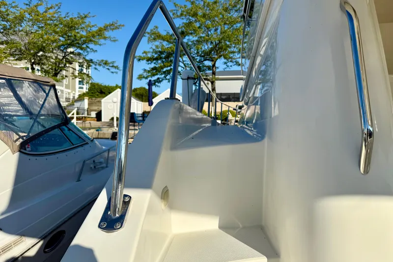  Yacht Photos Pics 2009 Carver 43 Super Sport yacht with sleek railing and docked boats in background.