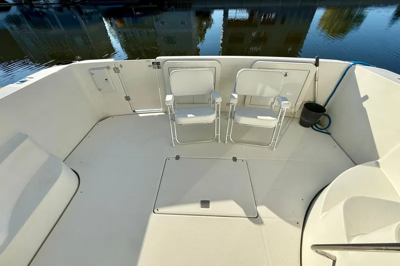  Yacht Photos Pics 2009 Carver 43 Super Sport boat deck with two chairs, docked by calm water.