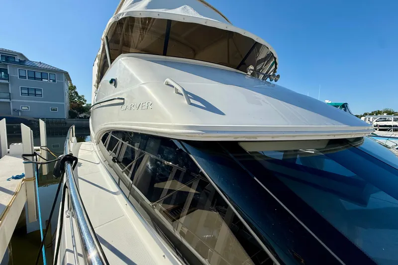  Yacht Photos Pics 2009 Carver 43 Super Sport yacht docked at marina under clear blue sky.