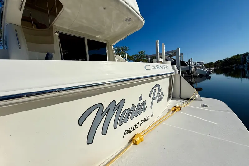  Yacht Photos Pics 2009 Carver 43 Super Sport yacht docked, featuring "Maria Pia" name and serene waterfront view.