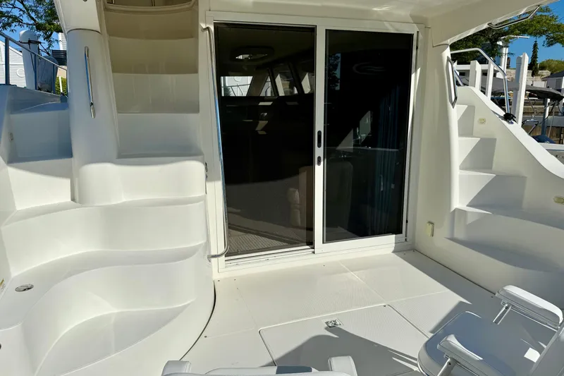 Yacht Photos Pics 2009 Carver 43 Super Sport yacht deck with sliding glass door and white seating.
