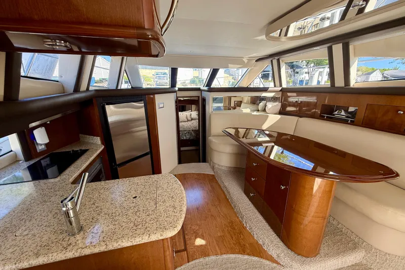  Yacht Photos Pics Luxurious interior of 2009 Carver 43 Super Sport yacht with modern kitchen and seating area.