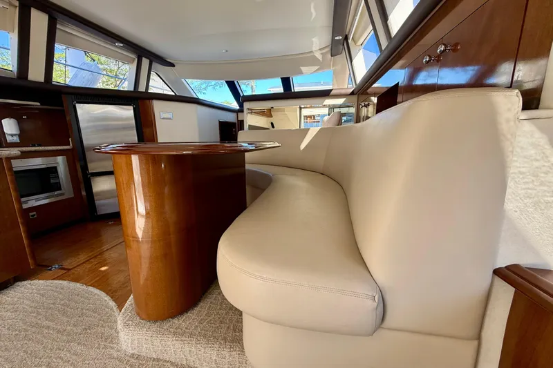  Yacht Photos Pics Luxurious interior of 2009 Carver 43 Super Sport yacht with elegant seating and wood finishes.