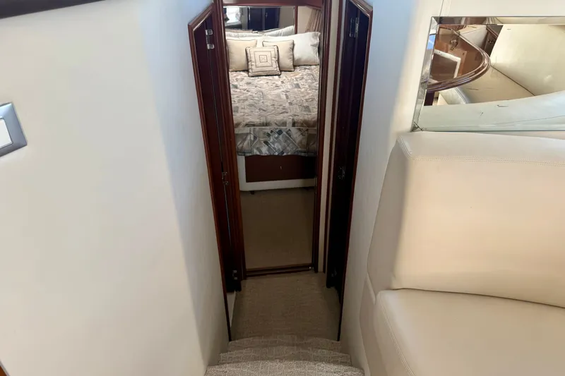  Yacht Photos Pics Interior view of 2009 Carver 43 Super Sport yacht, showing stairs leading to a cozy bedroom.