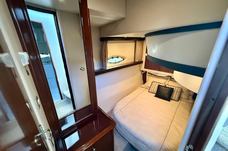  Yacht Photos Pics 2009 Carver 43 Super Sport yacht interior with cozy bedroom and elegant wood finishes.