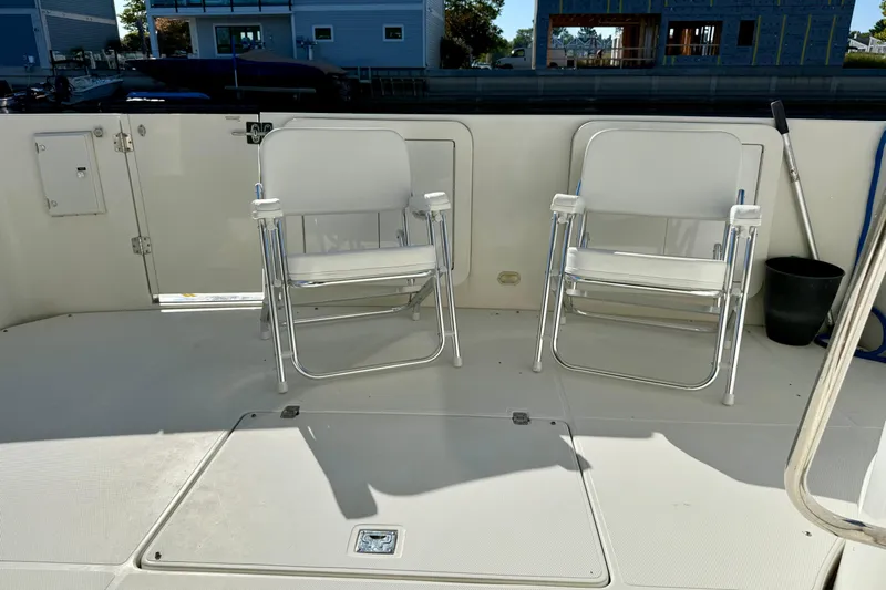  Yacht Photos Pics 2009 Carver 43 Super Sport deck with two white folding chairs.