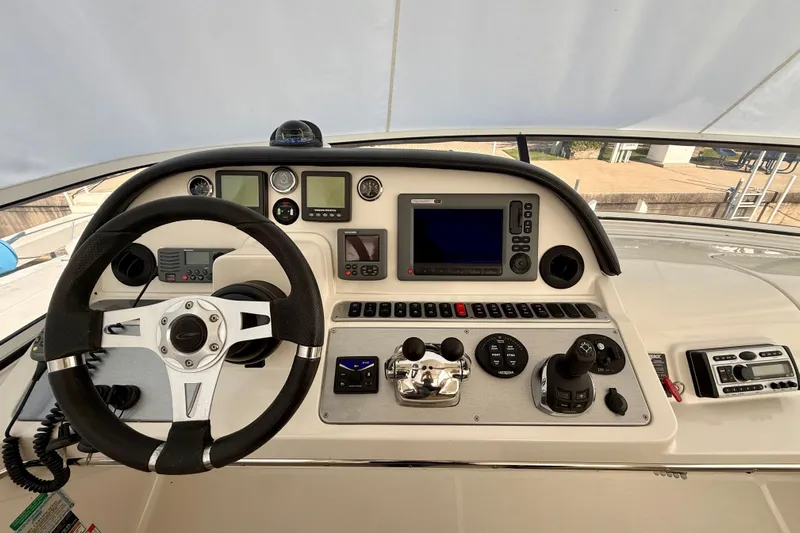  Yacht Photos Pics 2009 Carver 43 Super Sport helm with steering wheel and navigation controls.