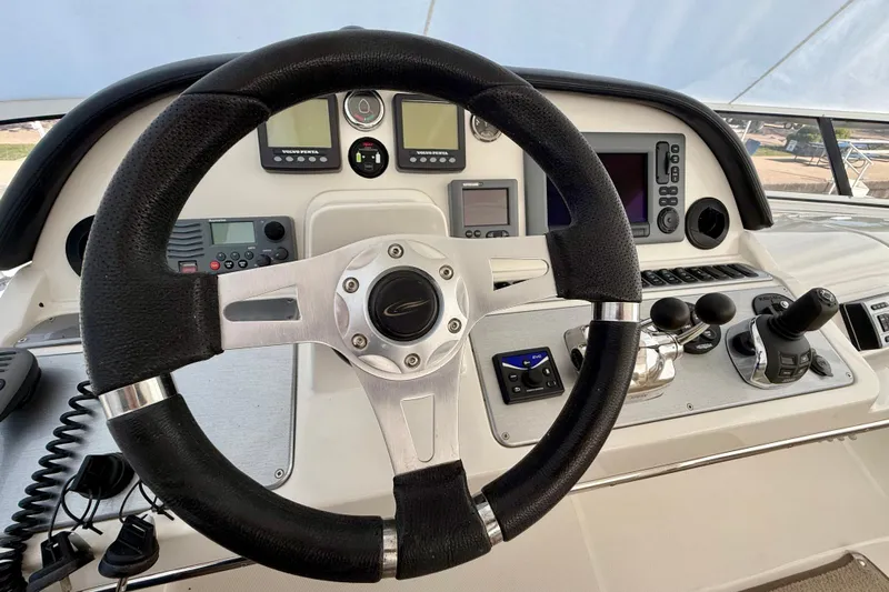  Yacht Photos Pics 2009 Carver 43 Super Sport helm with steering wheel and navigation controls.